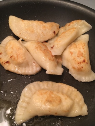Crisping up the perogies in butter